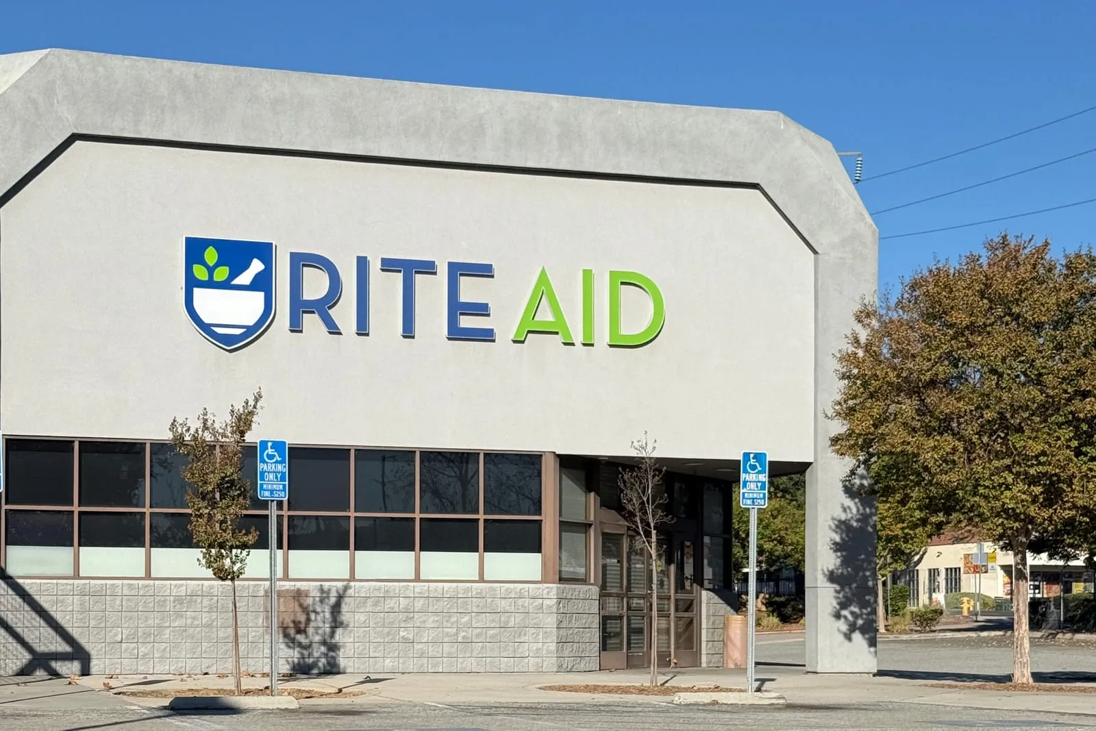 The closed Rite Aid pharmacy at Heacock and Ironwood, its sign still up over an empty parking lot.